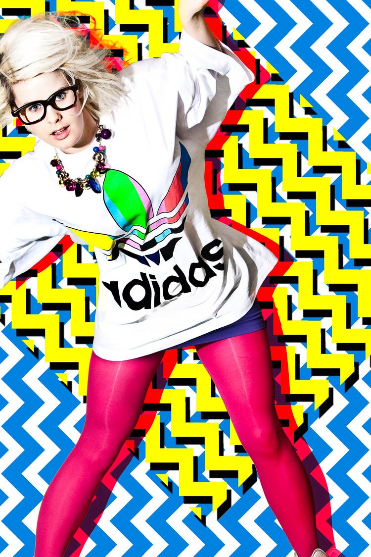 A model in sunglasses, a white sports top and pink leggings against bright zigzag patterns.