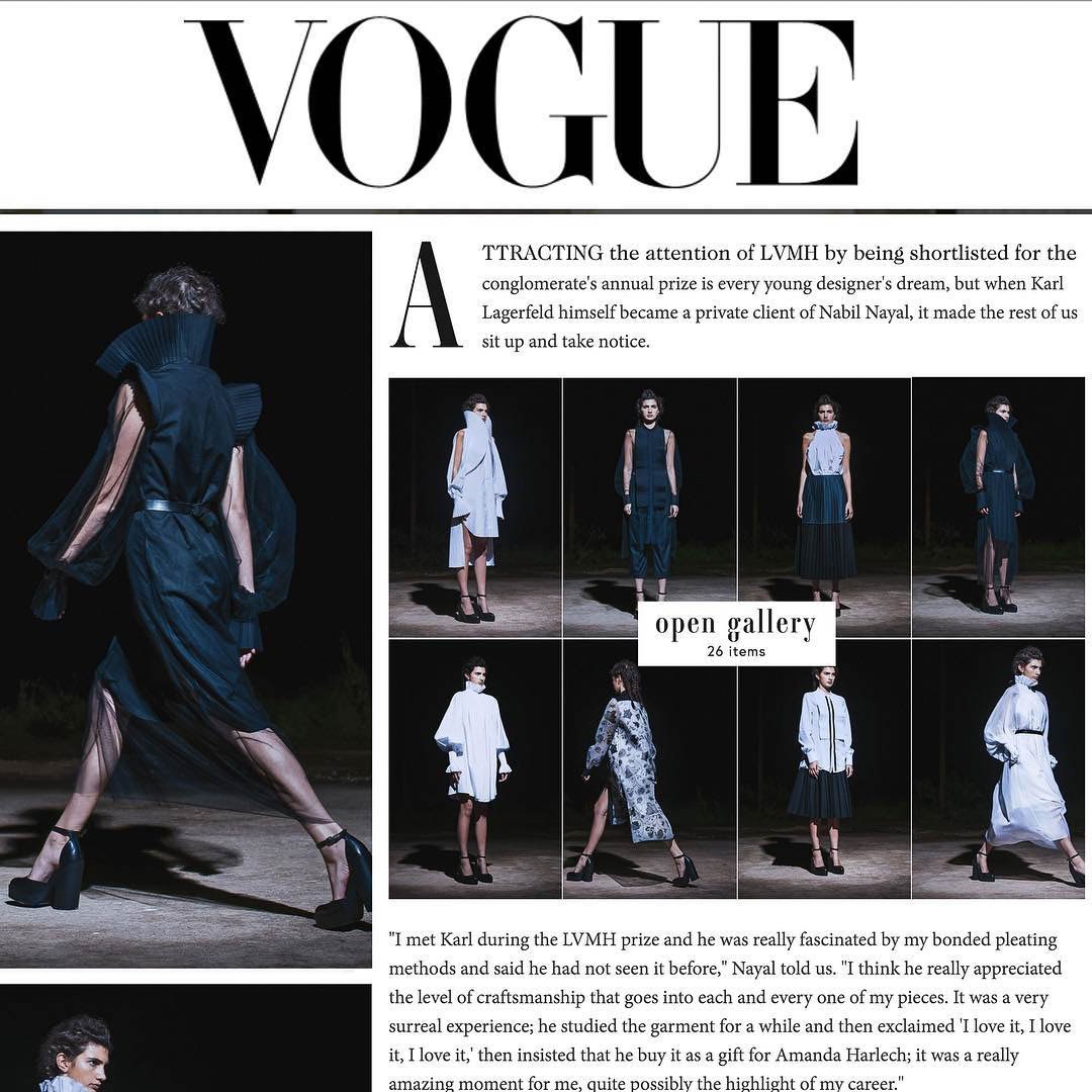 Vogue fashion feature with runway photographs of dark and pale sculptural outfits.