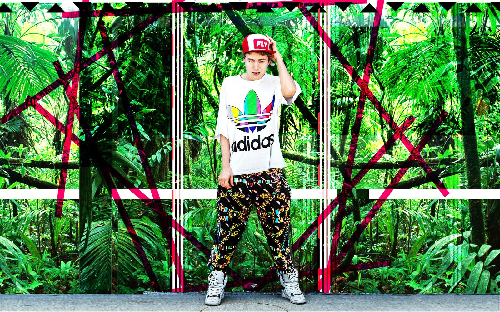 A model in a white sports top and patterned trousers inside a vivid green and pink structure.