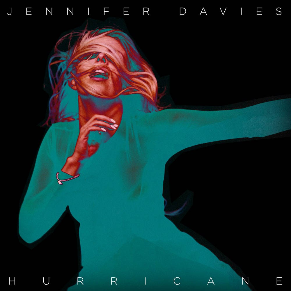 A red-haired performer in a turquoise top, with Jennifer Davies and Hurricane lettering.