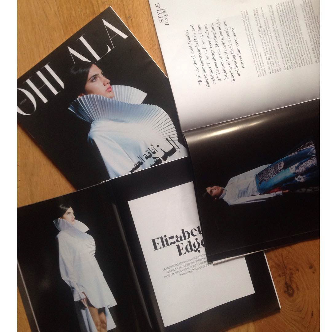 Photographed fashion magazine spread featuring pale structured clothing.
