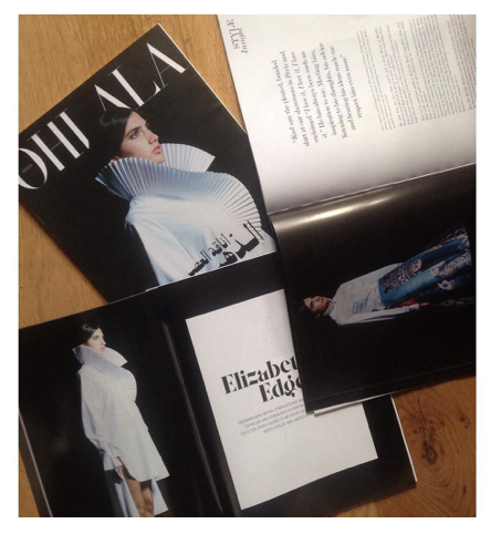Photographed fashion magazine spread featuring pale structured clothing.