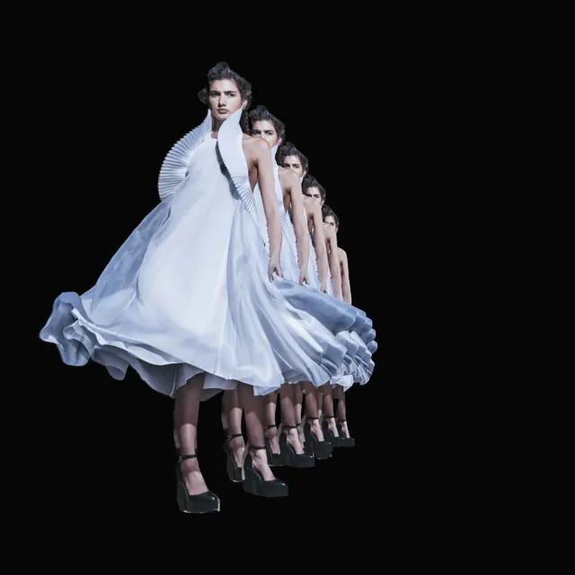 A model turning in a flowing white dress. Five figures repeat along a curved path in space as the viewpoint moves.